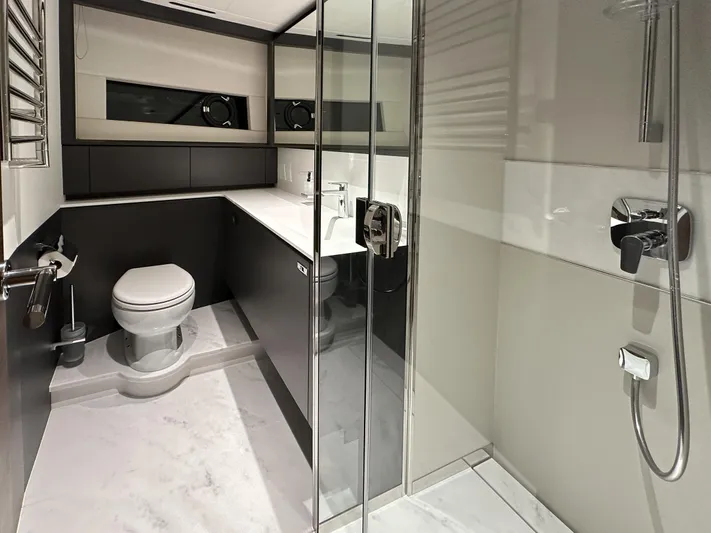 X80034 Yacht Photos Pics Luxurious bathroom in 2024 Princess X80 yacht with modern fixtures and glass shower.