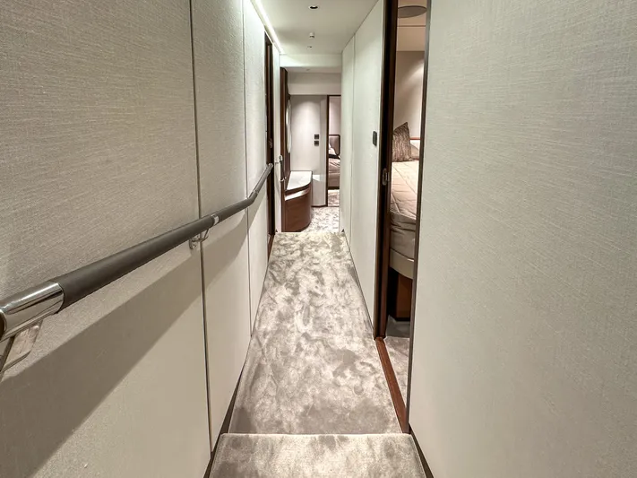 X80034 Yacht Photos Pics Luxurious hallway inside 2024 Princess X80 yacht, featuring elegant design and plush carpeting.