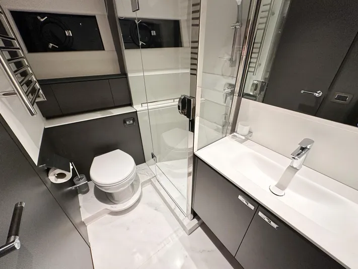 X80034 Yacht Photos Pics Modern bathroom in 2024 Princess X80 yacht with sleek fixtures and glass shower.