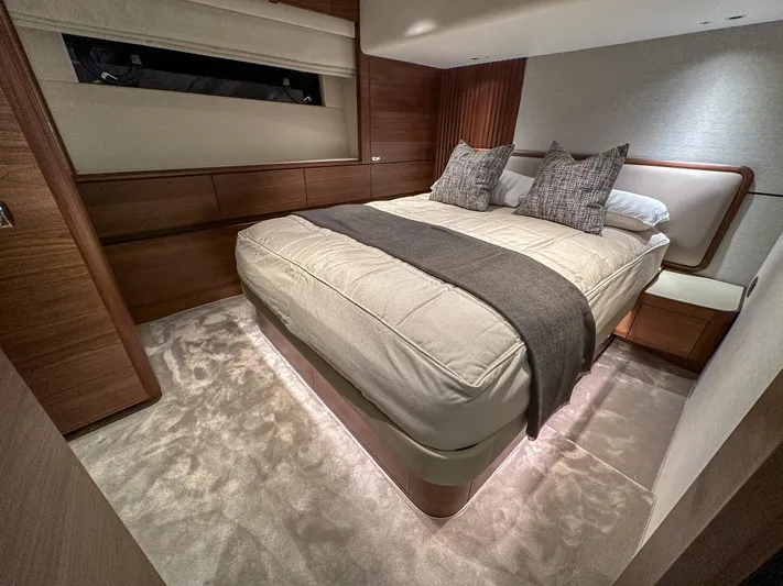 X80034 Yacht Photos Pics Luxurious bedroom interior of 2024 Princess X80 yacht with elegant wood finishes.