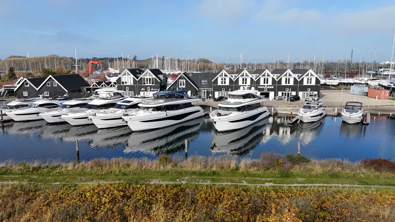 X80034 Yacht Photos Pics Marina with 2024 Princess X80 yachts docked, surrounded by charming waterfront buildings.