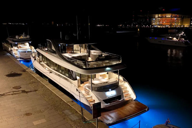 X80034 Yacht Photos Pics Luxurious 2024 Princess X80 yacht docked at night with elegant blue lighting.