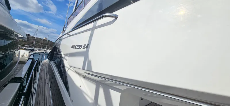  Yacht Photos Pics 2014 Princess 64 yacht docked under a blue sky.