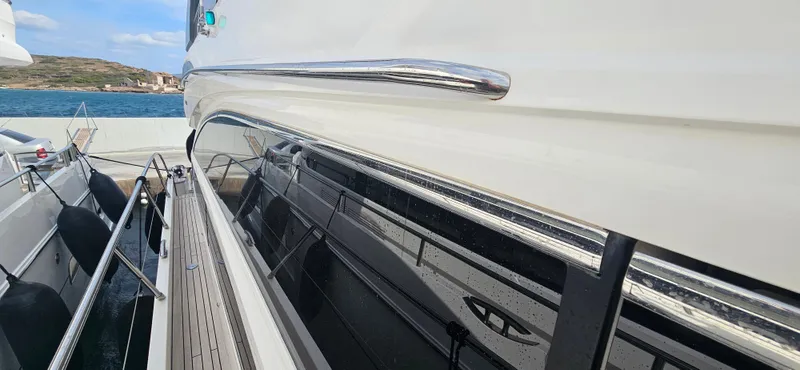  Yacht Photos Pics Side view of a 2014 Princess 64 yacht docked by the sea.