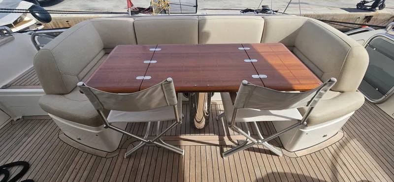  Yacht Photos Pics Luxury yacht Princess 64, 2014 model, featuring elegant outdoor seating and wooden table.