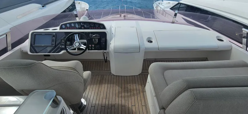  Yacht Photos Pics Cockpit of 2014 Princess 64 yacht with modern controls and seating.