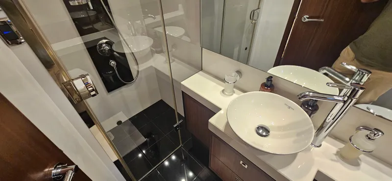  Yacht Photos Pics Luxurious bathroom in a 2014 Princess 64 yacht, featuring modern fixtures and elegant design.