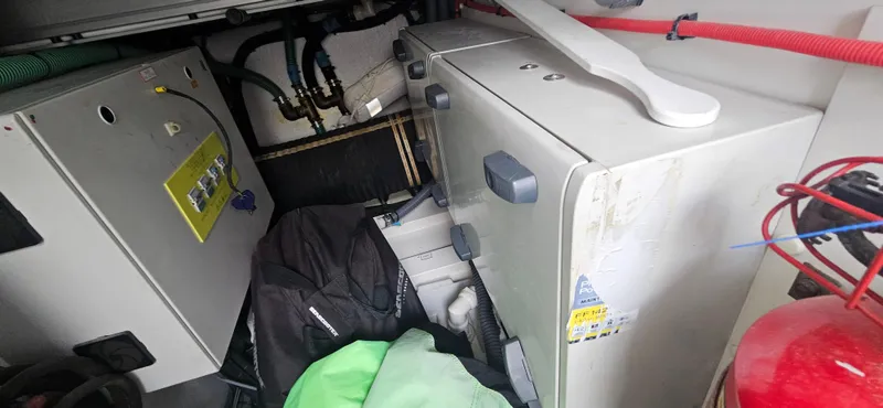  Yacht Photos Pics Engine room of a 2014 Princess 64 yacht with equipment and storage items.