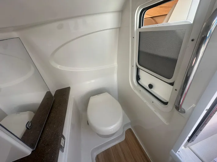  Yacht Photos Pics 2015 Formula 310 Bowrider bathroom interior with toilet and window.
