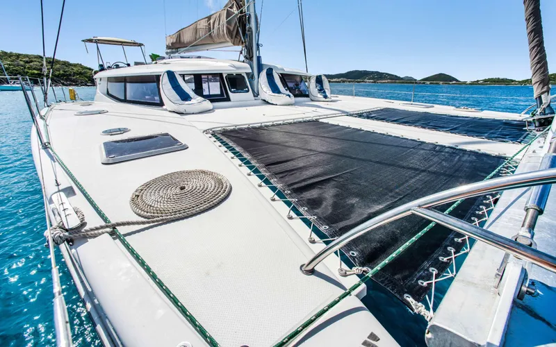 Endless Azul Yacht Photos Pics 2013 Fountaine Pajot Sanya 57 catamaran on clear blue water, featuring spacious deck.