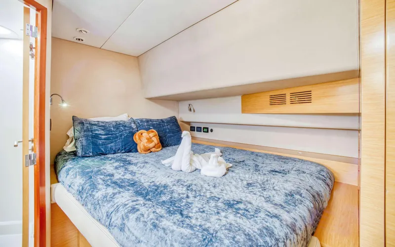 Endless Azul Yacht Photos Pics Cozy bedroom in 2013 Fountaine Pajot Sanya 57 yacht with blue bedding and decorative towels.