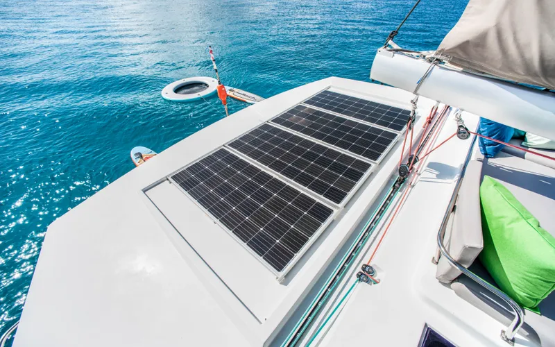 Endless Azul Yacht Photos Pics Fountaine Pajot Sanya 57 catamaran with solar panels, 2013 model, on clear blue water.