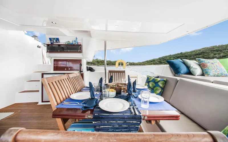 Endless Azul Yacht Photos Pics Luxurious dining area on 2013 Fountaine Pajot Sanya 57 yacht, featuring elegant table setting.