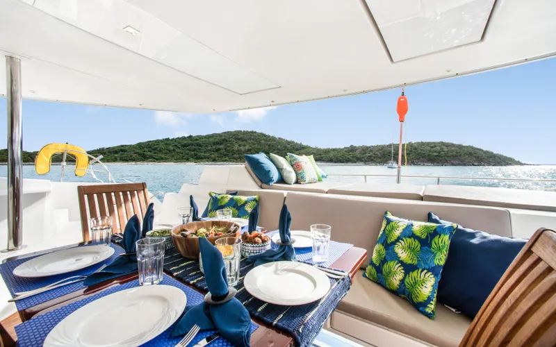 Endless Azul Yacht Photos Pics Luxurious dining setup on 2013 Fountaine Pajot Sanya 57 yacht with scenic ocean view.