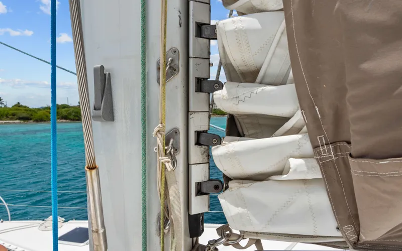 Endless Azul Yacht Photos Pics Close-up of a 2013 Fountaine Pajot Sanya 57 sailboat mast and sail, with ocean background.