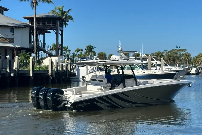  Yacht Photos Pics 2022 Fountain 38 CC LS boat docked at marina with palm trees and clear sky.