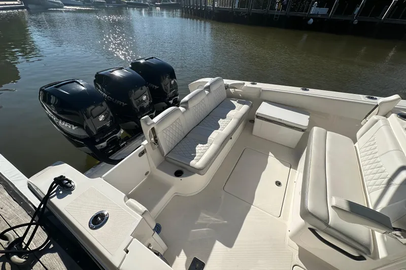  Yacht Photos Pics 2022 Fountain 38 CC LS boat with triple Mercury engines, docked on calm water.
