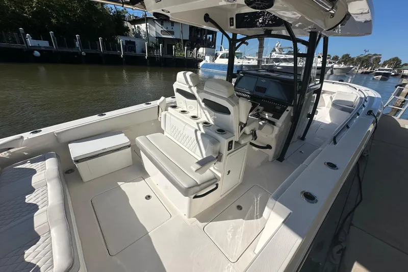  Yacht Photos Pics 2022 Fountain 38 CC LS boat interior with seating and control panel at marina.