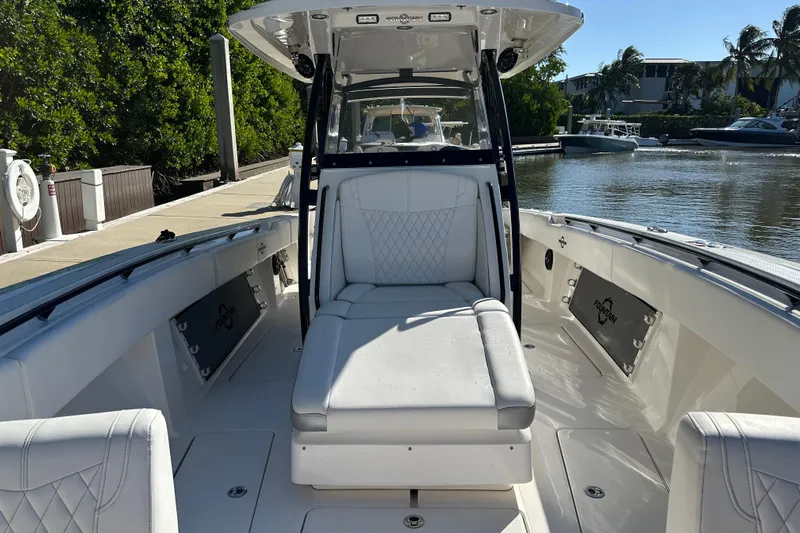  Yacht Photos Pics 2022 Fountain 38 CC LS boat interior with white seating, docked by the water.