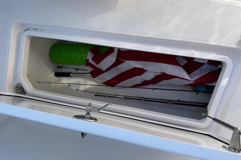 Yacht Photos Pics Open storage compartment on 2022 Fountain 38 CC LS boat with fishing rods and gear.