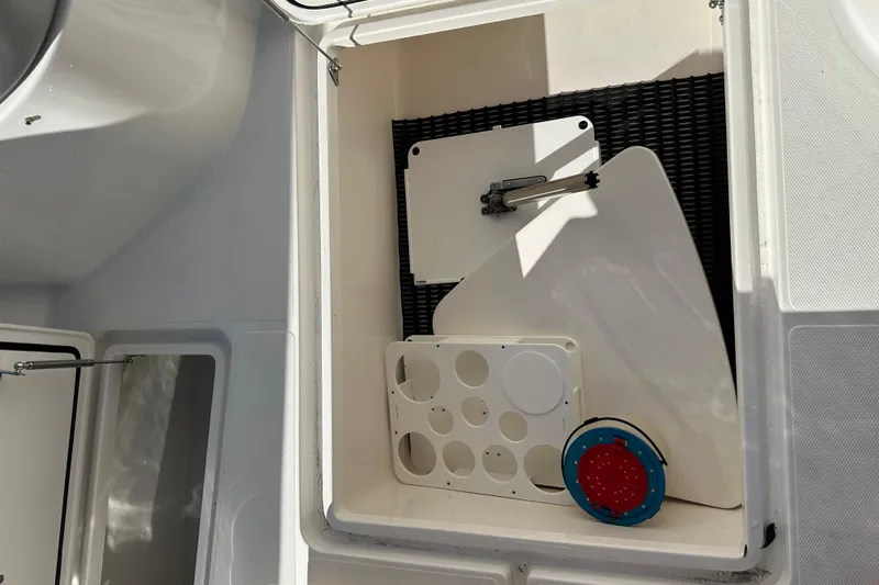  Yacht Photos Pics Storage compartment on 2022 Fountain 38 CC LS boat with various accessories.