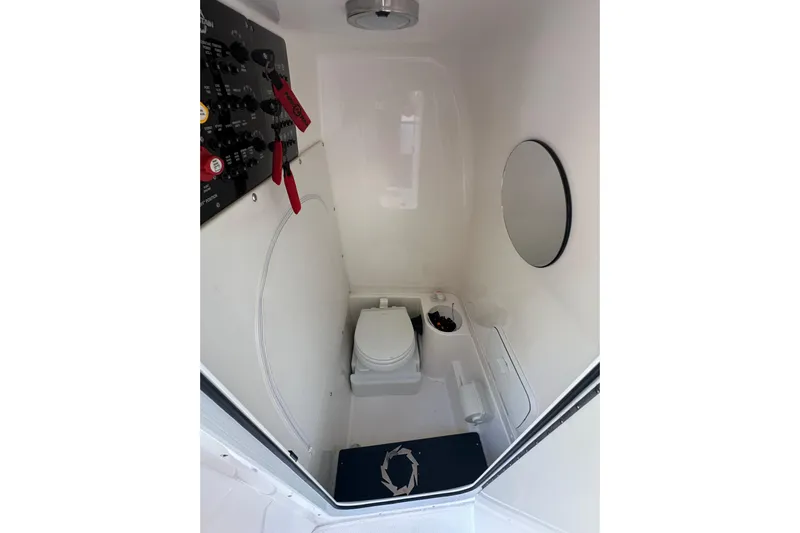  Yacht Photos Pics Interior of 2022 Fountain 38 CC LS boat bathroom with toilet and control panel.