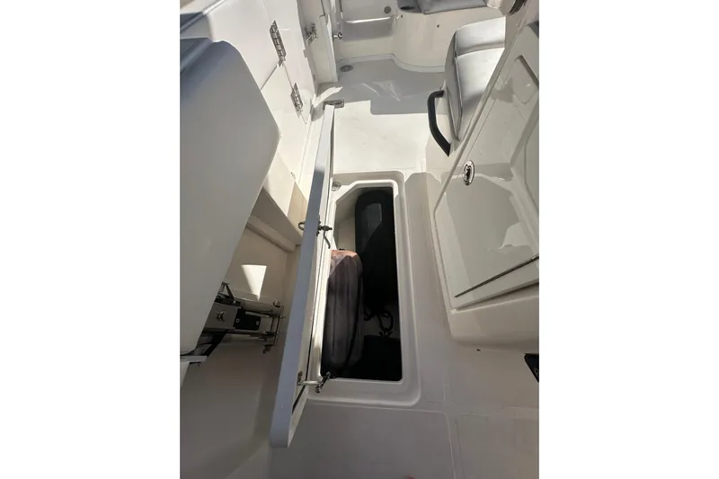  Yacht Photos Pics 2022 Fountain 38 CC LS boat interior storage compartment with open hatch.