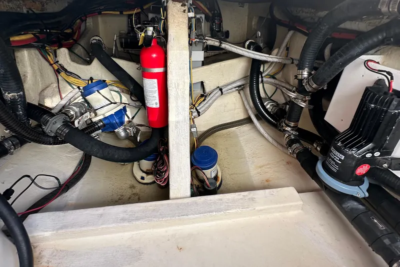  Yacht Photos Pics Engine compartment of 2022 Fountain 38 CC LS boat with hoses and fire extinguisher.