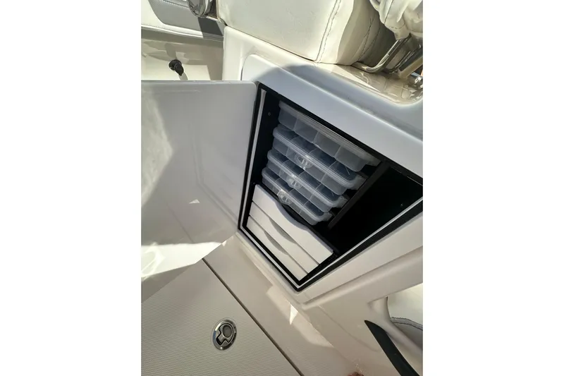  Yacht Photos Pics 2022 Fountain 38 CC LS boat storage compartment with organized trays.