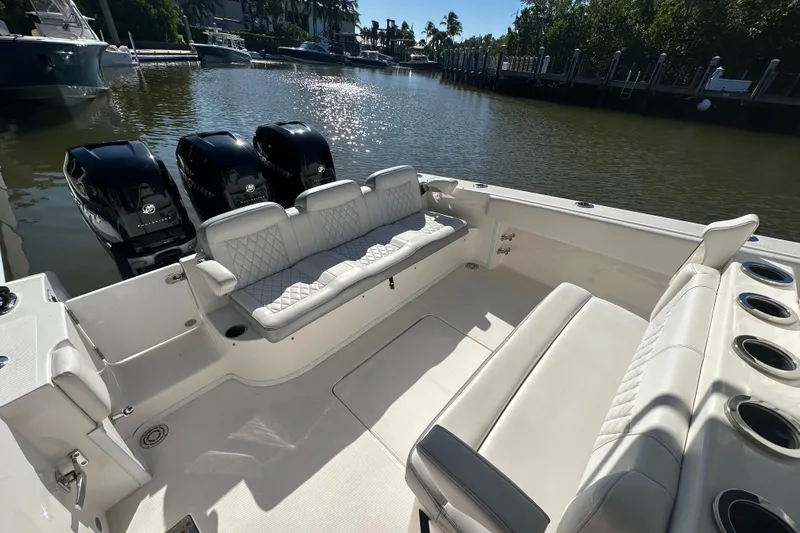  Yacht Photos Pics 2022 Fountain 38 CC LS boat interior with seating and triple outboard engines.
