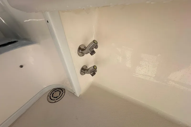  Yacht Photos Pics 2022 Fountain 38 CC LS boat interior with chrome fixtures and drainage system.