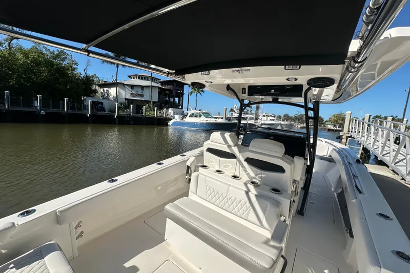  Yacht Photos Pics 2022 Fountain 38 CC LS boat docked, featuring spacious seating and sleek design.