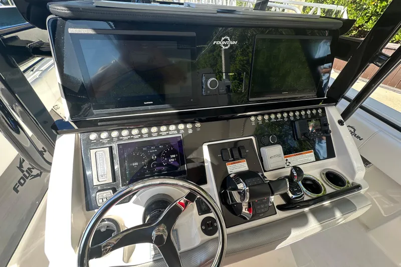  Yacht Photos Pics 2022 Fountain 38 CC LS boat dashboard with advanced controls and navigation screens.
