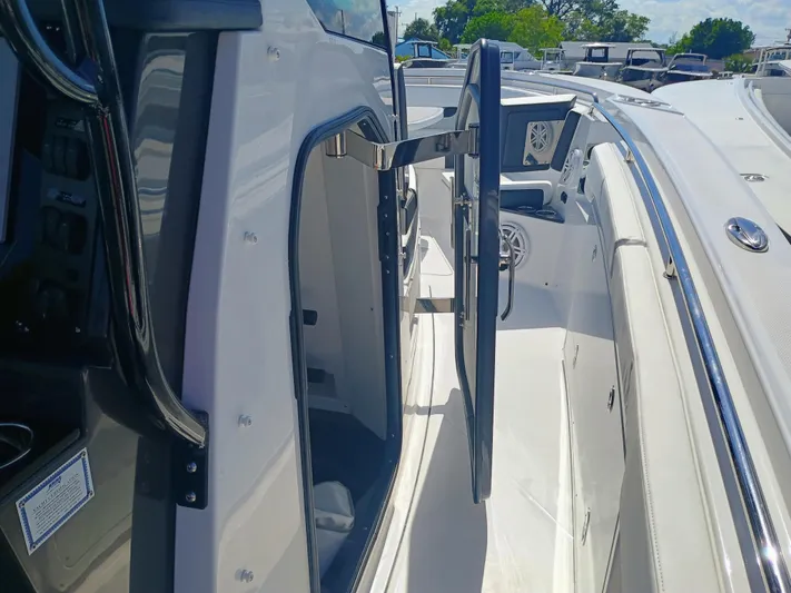  Yacht Photos Pics 2025 Blackfin 332 CC boat interior with open door, showcasing sleek design and spacious layout.