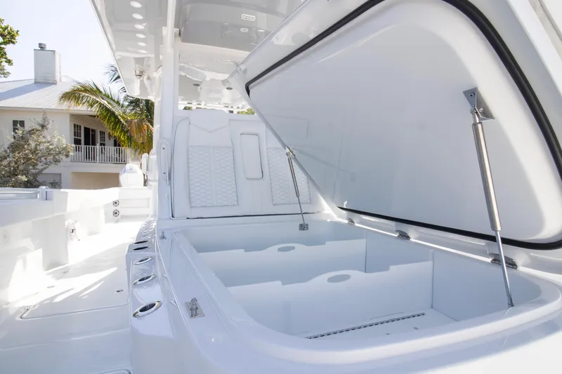  Yacht Photos Pics 2026 Invincible 36 Catamaran with open storage compartment, sleek white design.