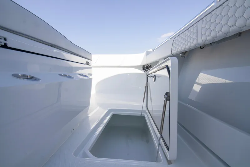  Yacht Photos Pics 2026 Invincible 36 Catamaran storage compartment with open hatch, showcasing sleek design.