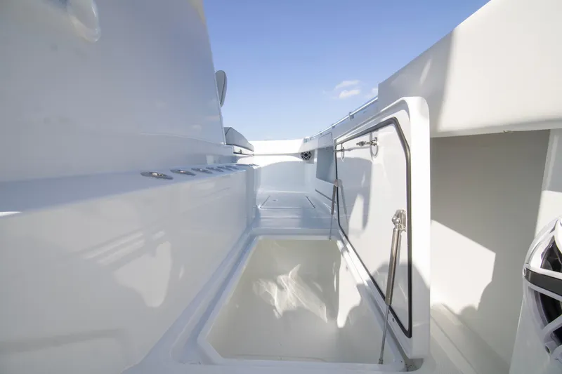  Yacht Photos Pics 2026 Invincible 36 Catamaran interior with open storage compartment and sleek design.