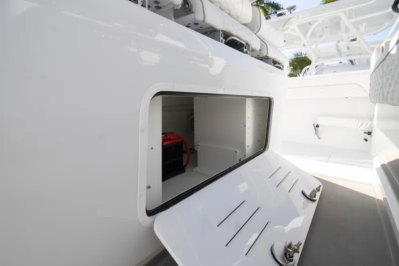  Yacht Photos Pics 2026 Invincible 36 Catamaran storage compartment with open hatch, showcasing interior space.