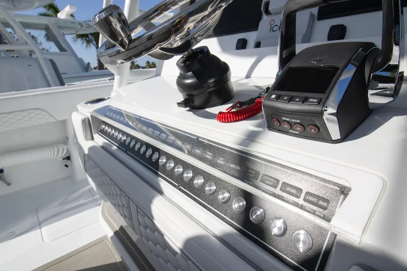  Yacht Photos Pics Control panel of 2026 Invincible 36 Catamaran with steering wheel and electronic controls.