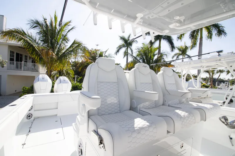  Yacht Photos Pics Luxurious seating on 2026 Invincible 36 Catamaran, surrounded by palm trees.