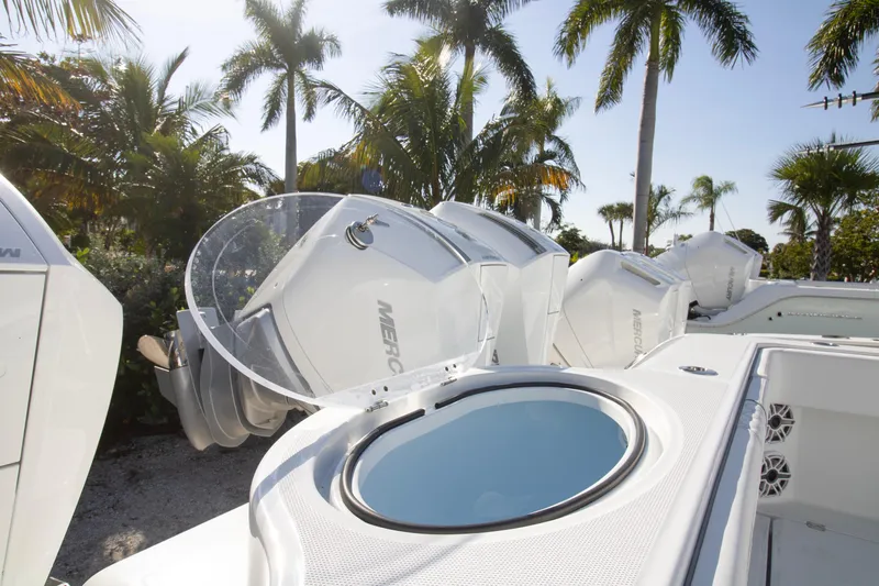  Yacht Photos Pics 2026 Invincible 36 Catamaran with powerful Mercury outboard engines, surrounded by palm trees.