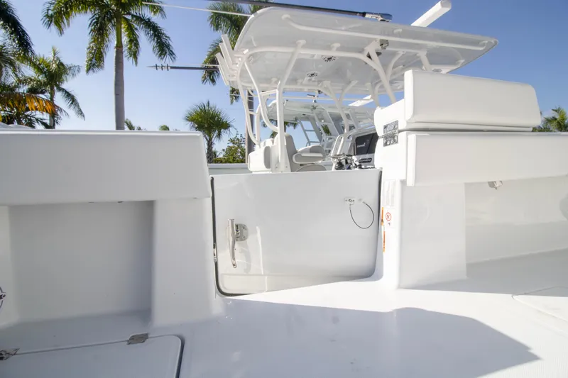  Yacht Photos Pics 2026 Invincible 36 Catamaran interior with sleek white design and palm trees in background.
