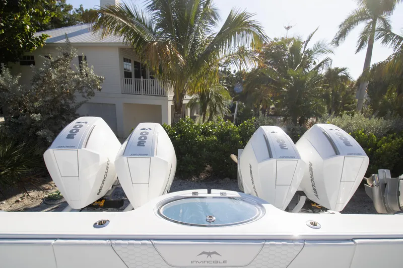  Yacht Photos Pics 2026 Invincible 36 Catamaran with four Mercury outboard engines, tropical backdrop.