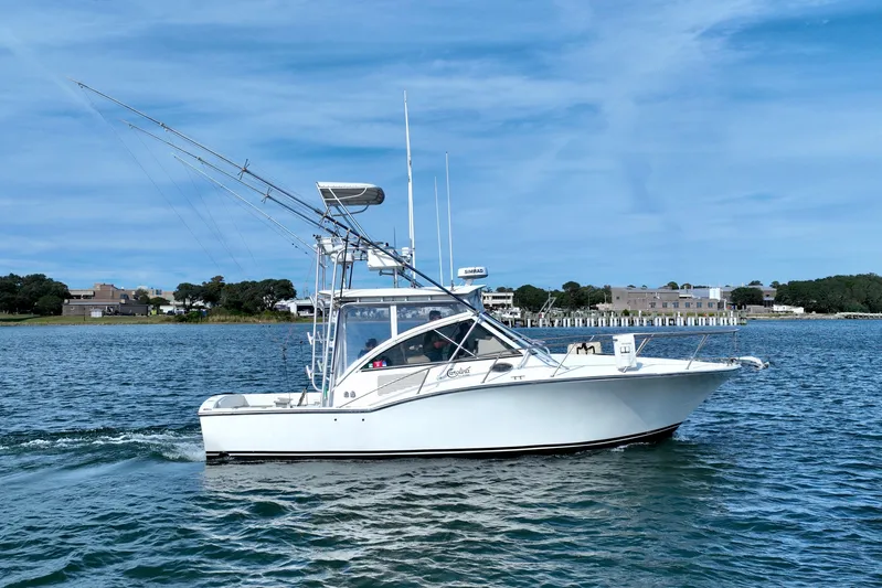 Barbara Ann Yacht Photos Pics 2001 Carolina Classic 35 Express boat cruising on a calm blue waterway.