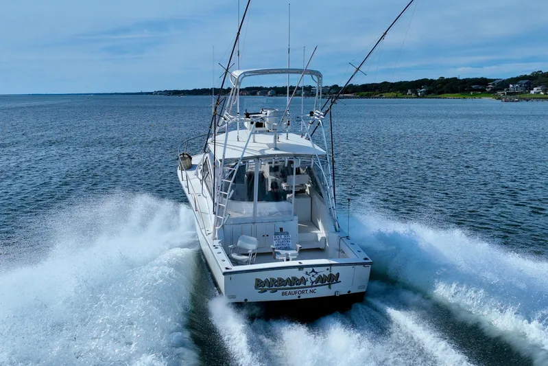 Barbara Ann Yacht Photos Pics 2001 Carolina Classic 35 Express boat cruising on open water, rear view.