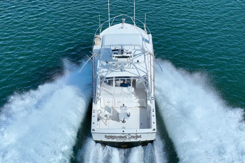 Barbara Ann Yacht Photos Pics 2001 Carolina Classic 35 Express boat cruising on open water, rear view.