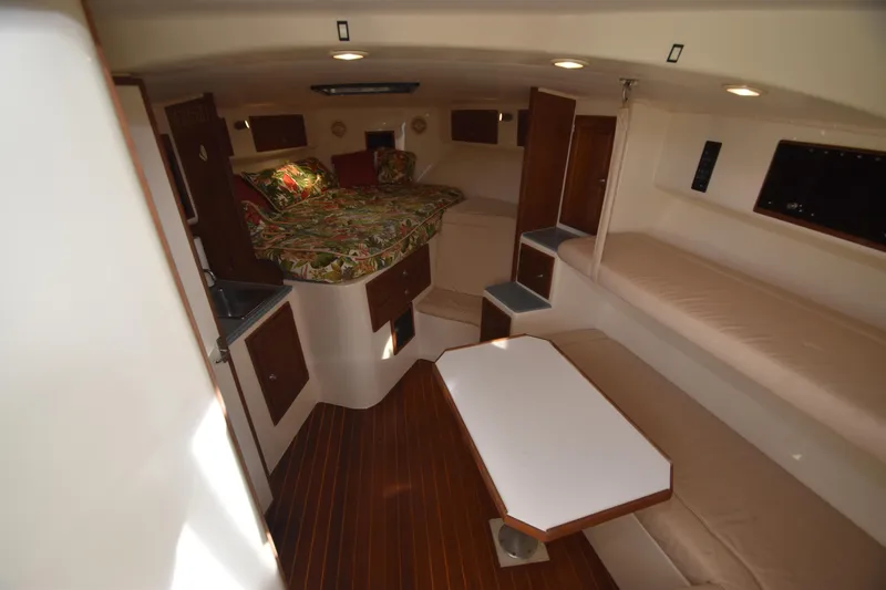 Barbara Ann Yacht Photos Pics 2001 Carolina Classic 35 Express cabin interior with cozy bedding and seating area.