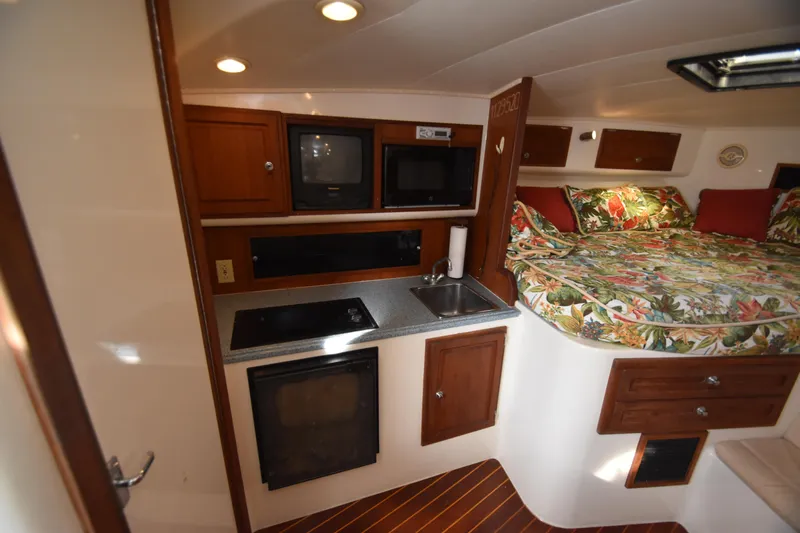 Barbara Ann Yacht Photos Pics 2001 Carolina Classic 35 Express cabin interior with kitchenette and cozy bed.