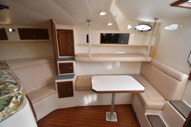Barbara Ann Yacht Photos Pics 2001 Carolina Classic 35 Express cabin interior with seating, table, and storage.