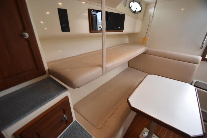 Barbara Ann Yacht Photos Pics 2001 Carolina Classic 35 Express cabin interior with beige seating and wooden accents.